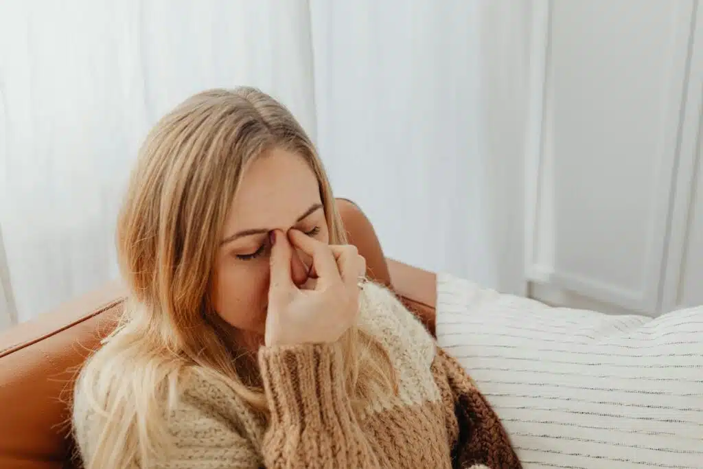 Woman Holding Her Nose Because of Sinus Pain 